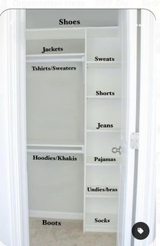 an open closet with white shelves and black lettering