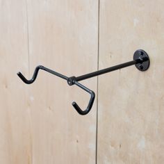 a metal hook on the side of a wooden wall