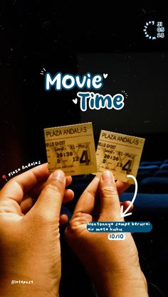 two people holding up tickets with the words movie time written on them in front of them