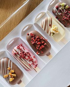 four different types of desserts in trays on a table