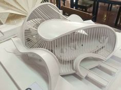 an architectural design, memaar is displayed on a table in front of other furniture