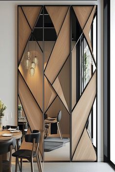 a dining room with a table and chairs next to a sliding glass door that has geometric designs on it