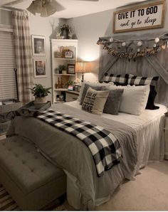 a bed room with a neatly made bed next to a window and some pictures on the wall