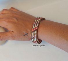 a person's arm with a bracelet on it