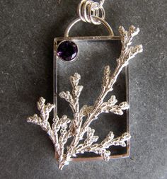 "Here is a handmade pendant made of sterling silver with an amethyst. I created a rectangular frame as the base of this pendant. I then cast a sprig of cypress from a tree in my yard. It is cast using a method like lost wax casting but in this cast it is lost plant casting. The plant material is burned away in my kiln leaving a cavity that is then filled with molten silver leaving an exact replica in solid sterling silver. A 6mm faceted amethyst is in the corner. The chain is sterling silver rou Lost Wax Casting Jewelry Pendants, Lost Wax Pendant, Wax Casting Jewelry, Lost Wax Casting Jewelry, Fused Jewelry, Texture Ideas, Silversmithing Jewelry, Jewelry Wax, Wax Carving