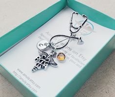 This unique keepsake brooch/pin is gorgeous in design and very unique! The stethoscope pin includes: -A PA Physician Assistant charm -An aluminum round disc stamped with your choice of initial (will NOT tarnish) -Your choice of birthstone Stethoscope pin measures 2.75 inches long with charms attached. Makes a great gift for upcoming graduation pinning ceremony or class graduation pins! Pin includes a FREE gift box! Titles available: RN, PA, PTA, PT, DPT, MA, CMA, MD, NP, RNP, LPN, LVN, DO, Rx, C Physician Assistant Gifts, Licensed Vocational Nurse, Pinning Ceremony Nurse, Gifts For Graduation, Medical Caduceus, Nurse Appreciation Week, Pinning Ceremony, Pa School, Thug Style