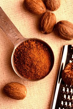 some nuts are next to a grater on a table