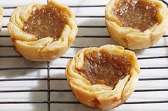 four small pastries sitting on top of a cooling rack