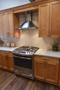 a stove top oven sitting inside of a kitchen next to wooden cabinets and cupboards