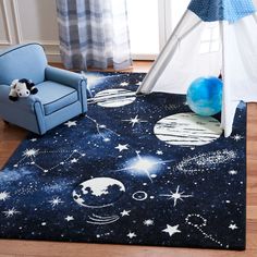 a child's room with a teepee tent, blue chair and stars rug