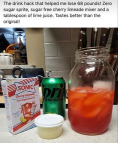 a jar filled with liquid next to a box of soda