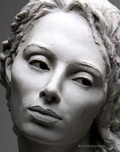 a sculpture of a woman with braids on her head