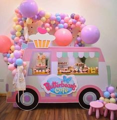 an ice cream truck is decorated with balloons