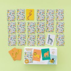 an assortment of children's cards and magnets on a green surface with yellow background