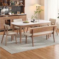 a dining room table with chairs and a bench