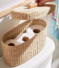 two wicker baskets holding toilet paper and rolls