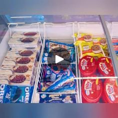 an open refrigerator filled with lots of food and snacks on top of it's shelves