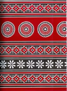 a red and black pattern with white circles on it's sides, in the middle