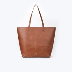 Product Overview: Upgrade your style with our handmade brown leather tote bag, crafted with care to meet your everyday needs. This stunning tote features luxurious lambskin leather, offering a combination of durability and sophistication. Perfect for daily commutes, shopping trips, or as a chic addition to your wardrobe, this tote is the definition of effortless style and function. Premium Quality Leather: Crafted from high-quality lambskin leather, this tote not only offers a sleek and polished Brown Bags With Leather Lining For Everyday Use, Brown Leather Lined Everyday Bag, Brown Leather Lining Bags For Everyday, Everyday Brown Bags With Leather Lining, Brown Shoulder Bag With Smooth Grain For Everyday Use, Brown Smooth Grain Shoulder Bag For Everyday Use, Brown Bags For Fall, Brown Smooth Grain Bags For Fall, Large Capacity Brown Leather Bag