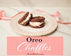 two oreo sandwiches on a white plate with pink ribbon around it and the words oreo chaffles