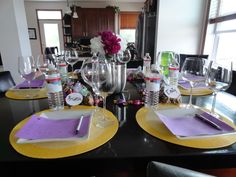 a dining room table with place settings and wine glasses