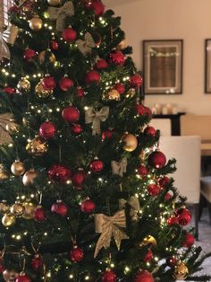 a decorated christmas tree with red and gold ornaments