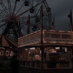 an amusement park at night with lights on