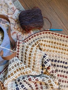 a crochet bag and yarn on the floor