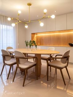 a dining room table and chairs in front of a wall with lights on it's sides