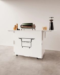 a white counter topped with a toaster and other items