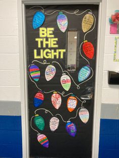 a door decorated with colorful paper hearts and the words be the light written on it