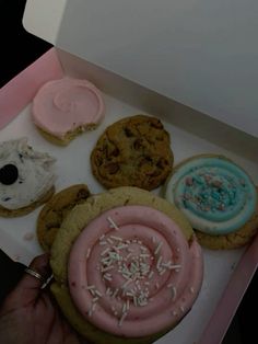 an open box filled with different types of cookies