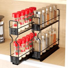 the spice rack is organized with spices and seasonings in black metal containers on wooden shelves