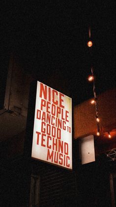 there is a sign that says nice people dancing to good tech music hanging from the ceiling