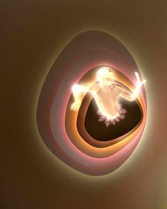 the light is shining brightly on the wall and ceiling in the shape of an egg