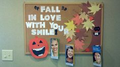 a bulletin board with pictures of people and pumpkins hanging from it's sides