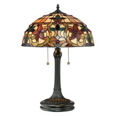 a table lamp with a stained glass shade on it's base and beads hanging from the bottom