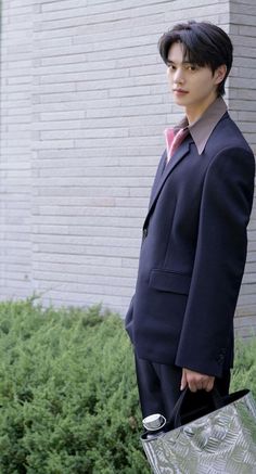 a man in a suit and tie holding a bag