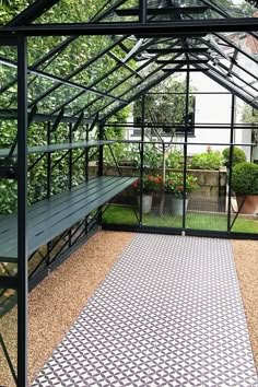 the inside of a small greenhouse with lots of plants