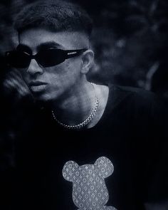 a man wearing sunglasses and a mickey mouse t - shirt