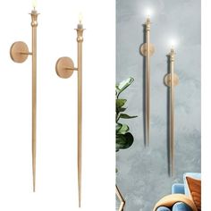 a pair of candles that are on the wall next to two poles with lights in them