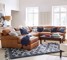 a living room filled with furniture and lots of windows