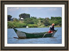 a man is sitting in a boat on the water