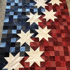 a red, white and blue quilt with stars on it