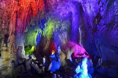 the inside of a cave with colorful lights