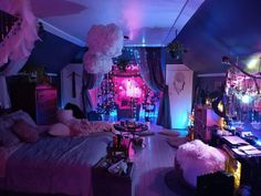 a bedroom decorated in pink and purple with lots of lights on the ceiling, furniture and decorations