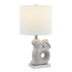 an elephant lamp with a white shade on the base and a light bulb attached to it