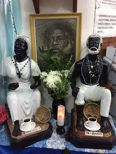 two statues sitting next to each other on a table