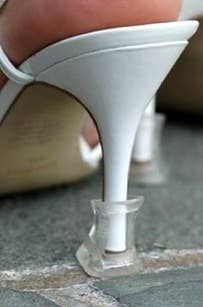 a woman's white high heeled shoes on the ground