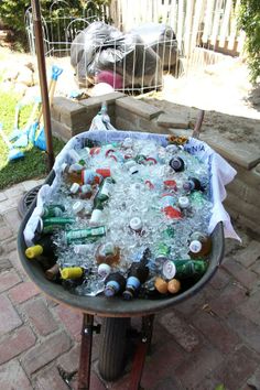 an outdoor table filled with bottles and cans